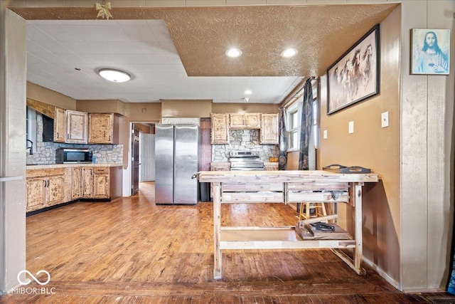 671 W 350 N, Shelbyville, IN 46176 - kitchen with appliances with stainless steel finishes, light wood-type flooring, decorative backsplash, light countertops, and recessed lighting