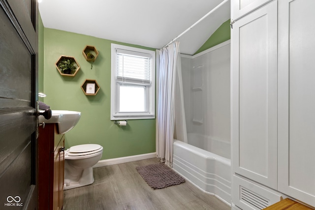 344 N Whittier Pl, Indianapolis, IN 46219 - full bathroom with wood finished floors, toilet, lofted ceiling, vanity, and shower / bath combo with shower curtain