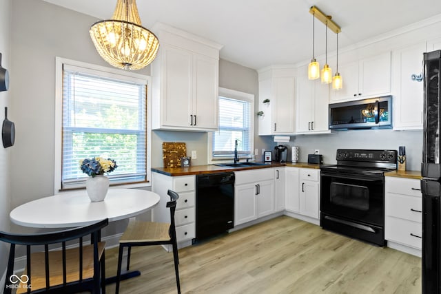 344 N Whittier Pl, Indianapolis, IN 46219 - kitchen with black appliances, wood counters, a sink, a chandelier, and light wood finished floors