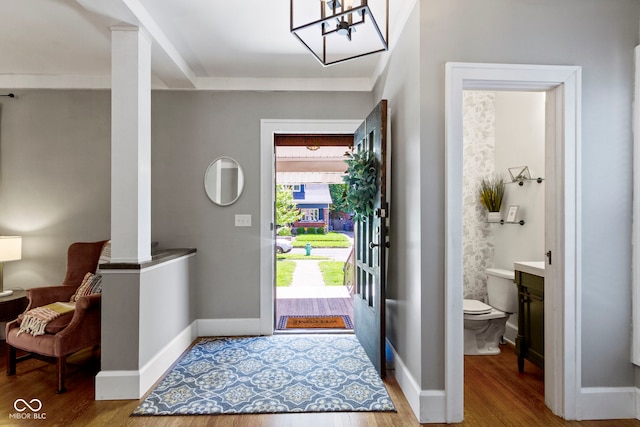 344 N Whittier Pl, Indianapolis, IN 46219 - foyer entrance with wood finished floors, a chandelier, and baseboards