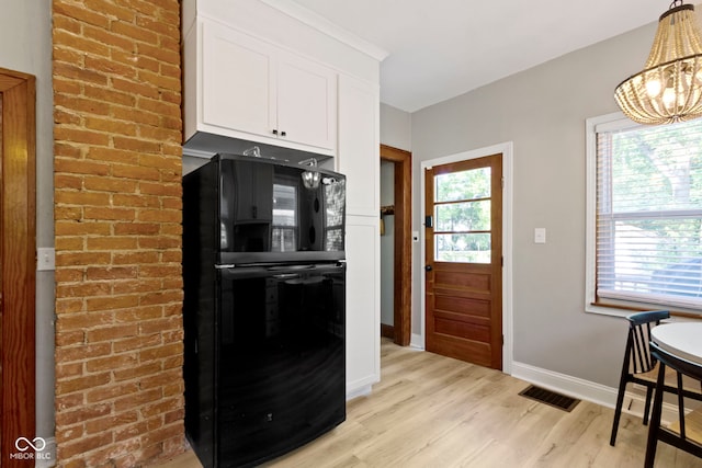 344 N Whittier Pl, Indianapolis, IN 46219 - kitchen with freestanding refrigerator, light wood finished floors, baseboards, white cabinets, and a chandelier