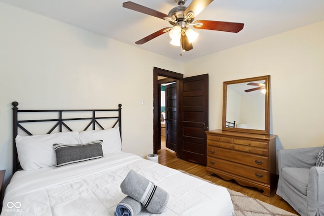 344 N Whittier Pl, Indianapolis, IN 46219 - bedroom featuring wood finished floors and a ceiling fan