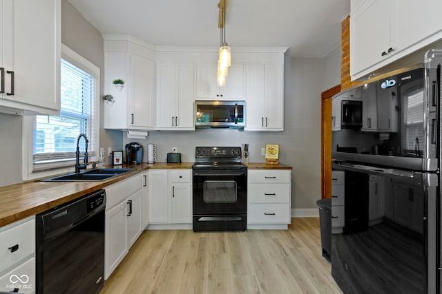 344 N Whittier Pl, Indianapolis, IN 46219 - kitchen with wooden counters, black appliances, a sink, white cabinetry, and light wood-style floors