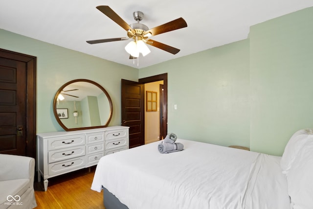 344 N Whittier Pl, Indianapolis, IN 46219 - bedroom with wood finished floors and a ceiling fan