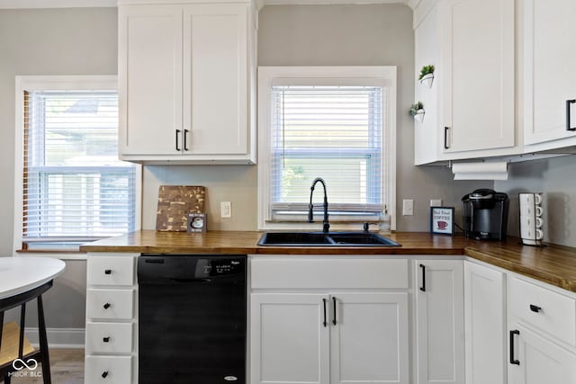 344 N Whittier Pl, Indianapolis, IN 46219 - kitchen with butcher block counters, dishwasher, a sink, and white cabinets