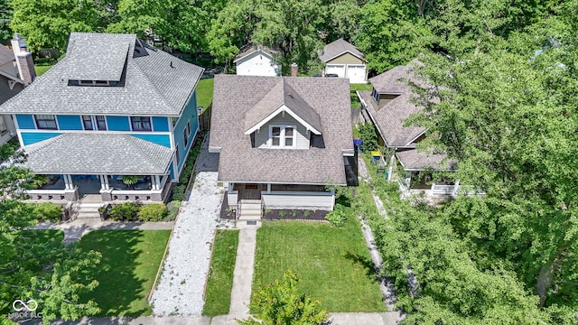 344 N Whittier Pl, Indianapolis, IN 46219 - view of front of house featuring a front lawn, roof with shingles, and a porch