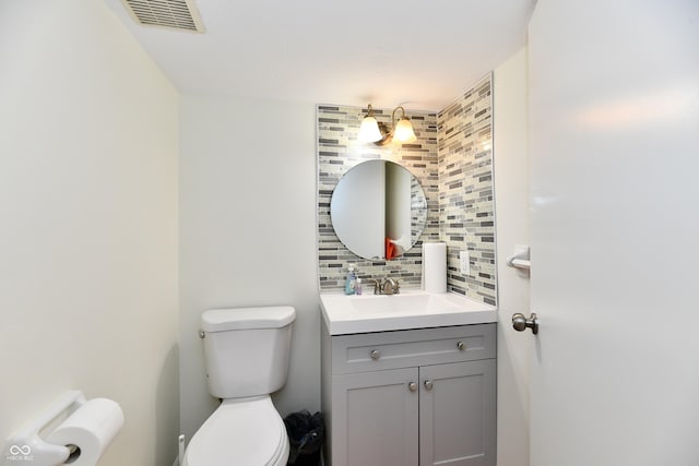 1310 Kings Cove Ct, Indianapolis, IN 46260 - half bath featuring toilet, decorative backsplash, and vanity