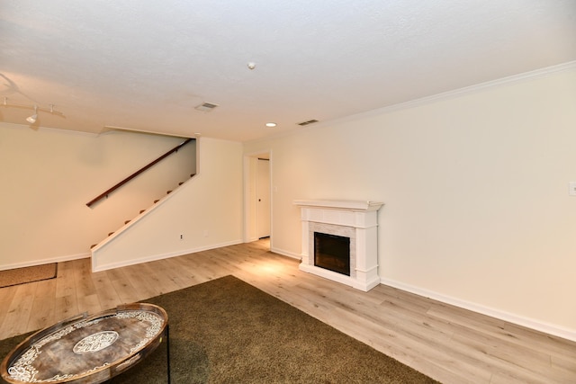 1310 Kings Cove Ct, Indianapolis, IN 46260 - unfurnished living room with wood finished floors, stairway, crown molding, baseboards, and a fireplace