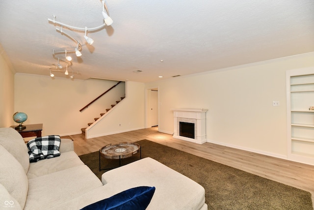 1310 Kings Cove Ct, Indianapolis, IN 46260 - living room with wood finished floors, stairs, built in shelves, baseboards, and a fireplace