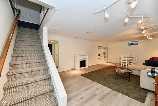 1310 Kings Cove Ct, Indianapolis, IN 46260 - living area featuring stairway, wood finished floors, baseboards, a fireplace, and built in shelves