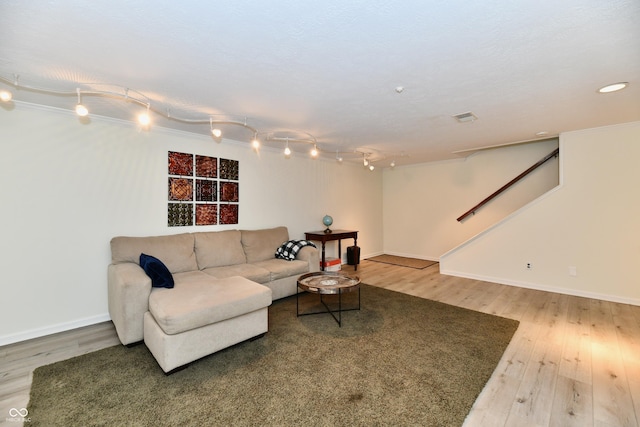 1310 Kings Cove Ct, Indianapolis, IN 46260 - living room with wood finished floors, baseboards, stairway, and rail lighting