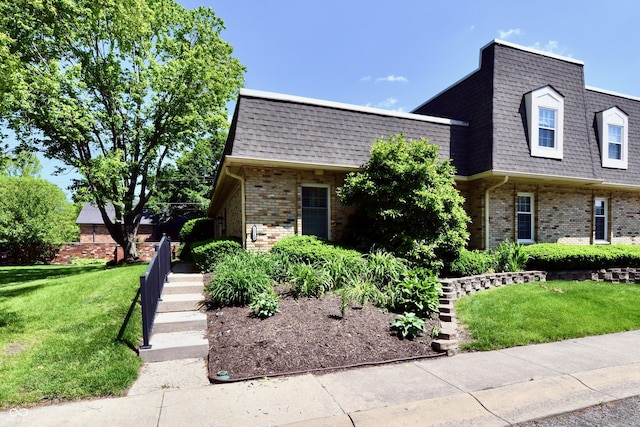 1310 Kings Cove Ct, Indianapolis, IN 46260 - view of front of property with brick siding, mansard roof, a front yard, and a shingled roof