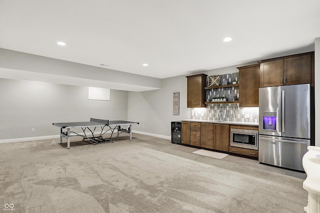 20010 Prescott Pl, Westfield, IN 46074 - indoor bar featuring appliances with stainless steel finishes, light colored carpet, baseboards, decorative backsplash, and recessed lighting