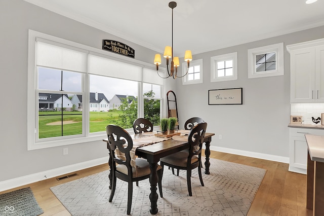 20010 Prescott Pl, Westfield, IN 46074 - dining room with crown molding, a chandelier, light wood-type flooring, and baseboards