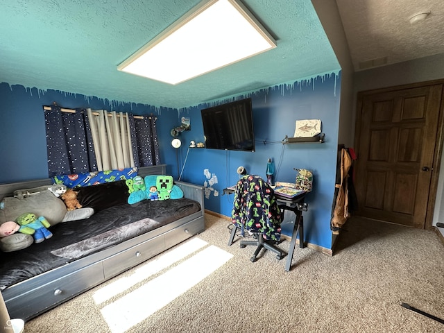 carpeted bedroom with a textured ceiling and baseboards