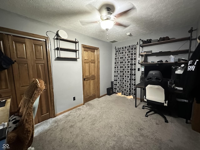 office featuring carpet, ceiling fan, a textured ceiling, and baseboards