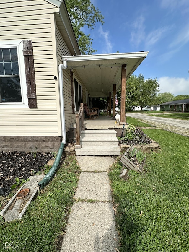 doorway to property with a yard