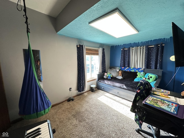 bedroom featuring carpet, baseboards, and a textured ceiling