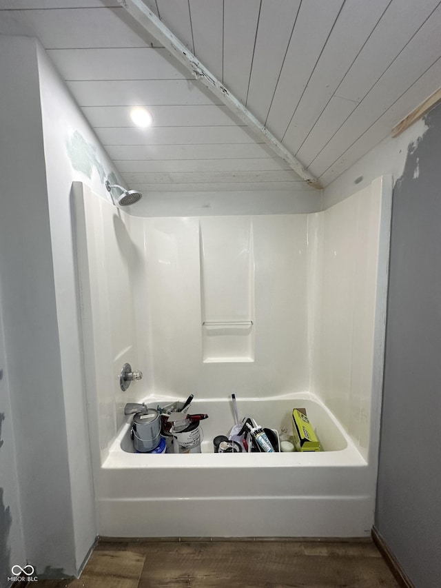 bathroom with bathing tub / shower combination, wood finished floors, and wood ceiling