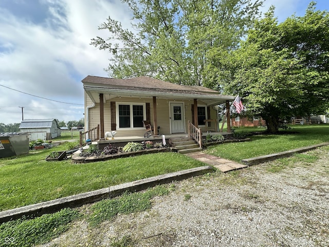 bungalow with a front lawn and a porch