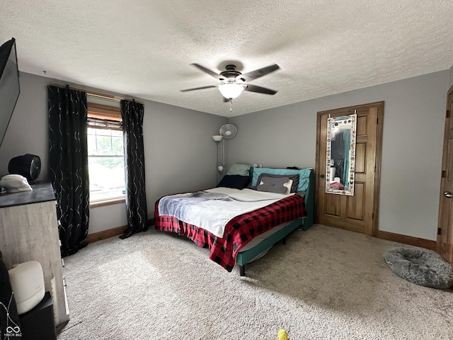 bedroom with carpet floors, a textured ceiling, baseboards, and ceiling fan