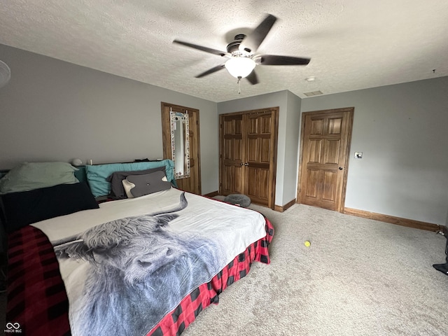 carpeted bedroom with baseboards, a textured ceiling, a closet, and a ceiling fan