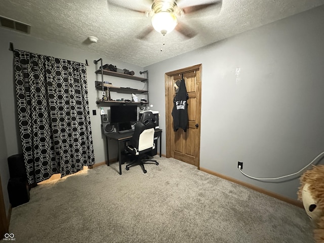 office area featuring ceiling fan, carpet flooring, a textured ceiling, and baseboards