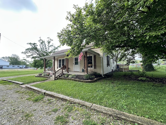view of front facade with covered porch and a front yard