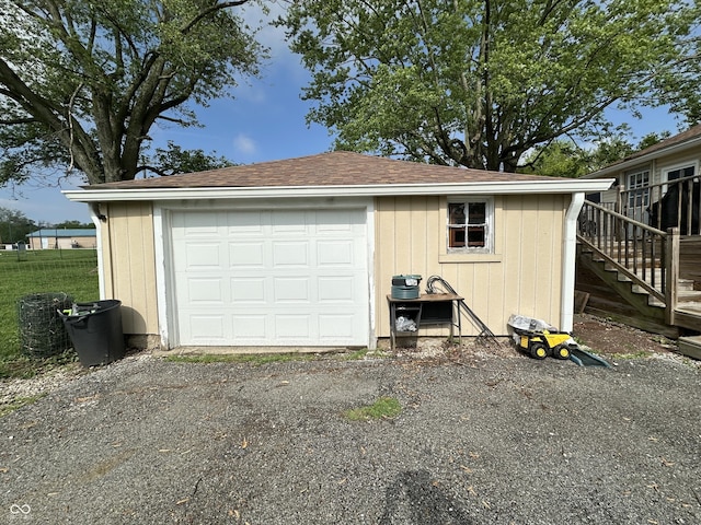 detached garage with asphalt driveway