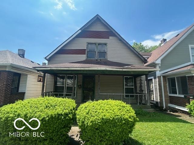 811 W 25th St, Indianapolis, IN 46208 - view of front of home featuring covered porch and a front yard