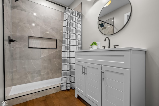 1825 E Maryland St, Indianapolis, IN 46201 - full bath with a tile shower, wood finished floors, and vanity