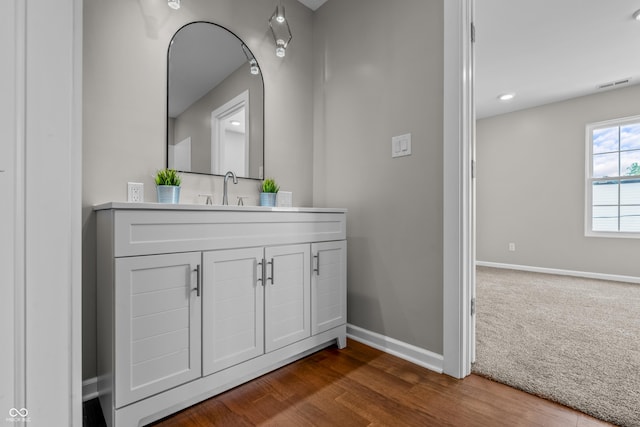 1825 E Maryland St, Indianapolis, IN 46201 - bathroom with baseboards, vanity, and wood finished floors