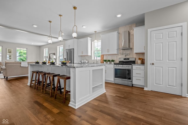1825 E Maryland St, Indianapolis, IN 46201 - kitchen featuring stainless steel appliances, wall chimney range hood, open floor plan, white cabinets, and recessed lighting