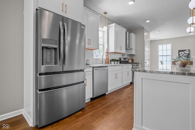 1825 E Maryland St, Indianapolis, IN 46201 - kitchen featuring stainless steel appliances, white cabinets, light stone countertops, wood finished floors, and recessed lighting