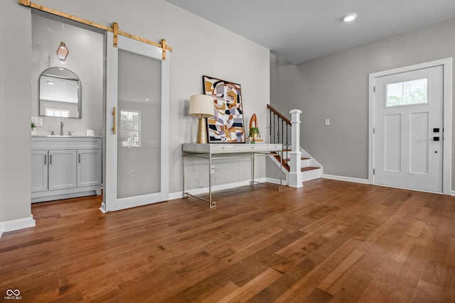 1825 E Maryland St, Indianapolis, IN 46201 - entryway with wood finished floors, baseboards, stairway, a barn door, and recessed lighting
