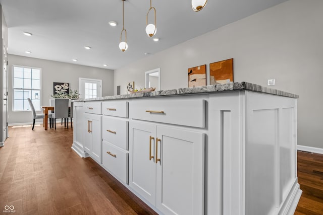 1825 E Maryland St, Indianapolis, IN 46201 - kitchen with white cabinetry, dark wood-style floors, light stone countertops, pendant lighting, and recessed lighting
