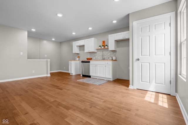 1825 E Maryland St, Indianapolis, IN 46201 - kitchen featuring stainless steel dishwasher, white cabinets, backsplash, light wood-type flooring, and recessed lighting