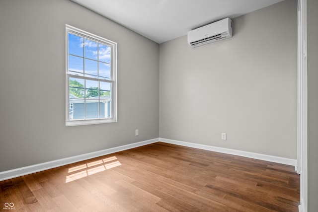 1825 E Maryland St, Indianapolis, IN 46201 - empty room featuring a wall mounted air conditioner, wood finished floors, and baseboards