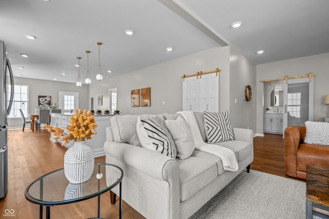 1825 E Maryland St, Indianapolis, IN 46201 - living area featuring wood finished floors, baseboards, a barn door, and recessed lighting