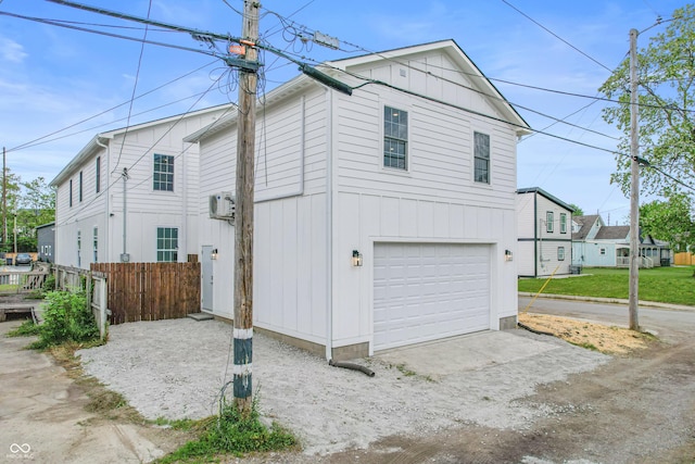 1825 E Maryland St, Indianapolis, IN 46201 - view of property exterior featuring an attached garage, driveway, and board and batten siding
