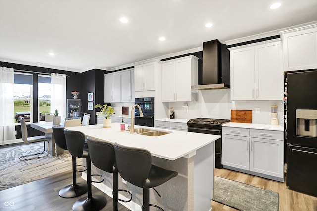 3592 Gillsland Rd, Bargersville, IN 46106 - kitchen with wall chimney exhaust hood, black appliances, a sink, recessed lighting, and a kitchen island with sink
