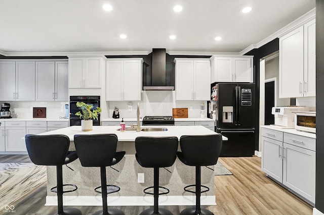3592 Gillsland Rd, Bargersville, IN 46106 - kitchen featuring black appliances, wall chimney range hood, a sink, a breakfast bar area, and light countertops