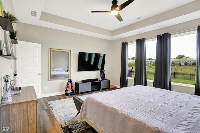 3592 Gillsland Rd, Bargersville, IN 46106 - bedroom with dark wood-style flooring, baseboards, a tray ceiling, and ceiling fan