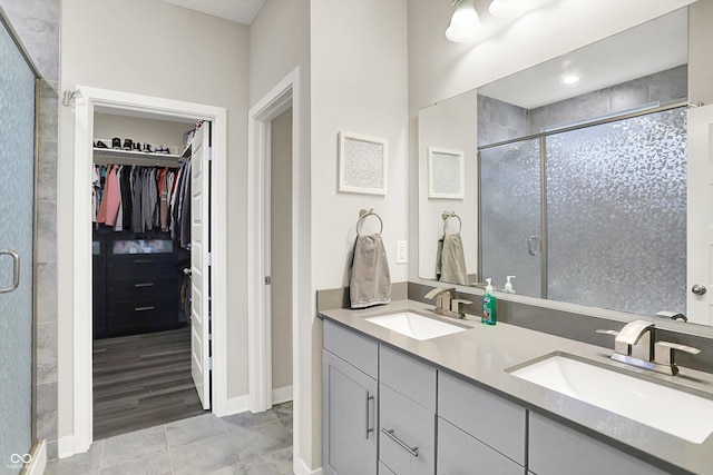 3592 Gillsland Rd, Bargersville, IN 46106 - full bathroom featuring a shower stall, a spacious closet, double vanity, tile patterned flooring, and baseboards