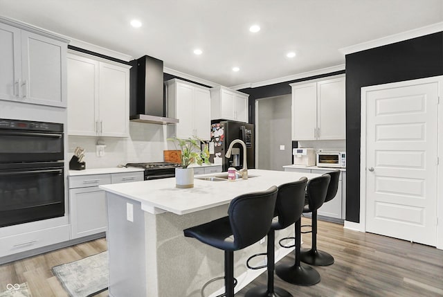 3592 Gillsland Rd, Bargersville, IN 46106 - kitchen with wall chimney range hood, black appliances, a sink, tasteful backsplash, and recessed lighting