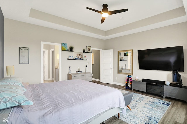 3592 Gillsland Rd, Bargersville, IN 46106 - bedroom with wood finished floors, a raised ceiling, baseboards, and a ceiling fan