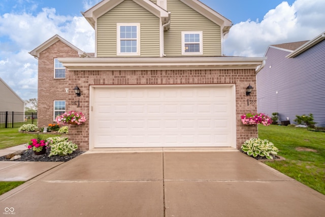 6579 Aster Dr, Pendleton, IN 46064 - view of front of house with brick siding, driveway, and a garage