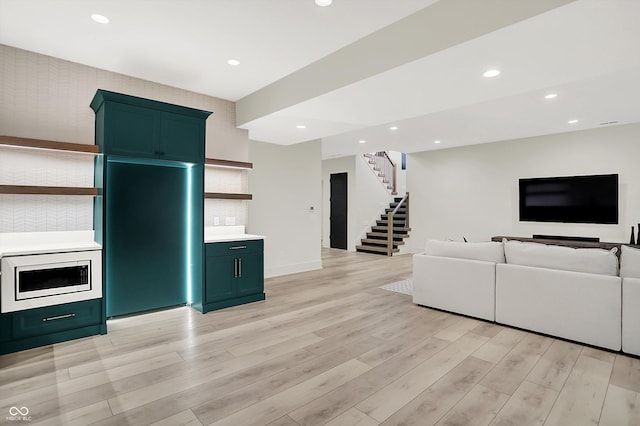 7116 Trail Ridge Ln, Indianapolis, IN 46259 - living area featuring stairway, light wood-style flooring, and recessed lighting