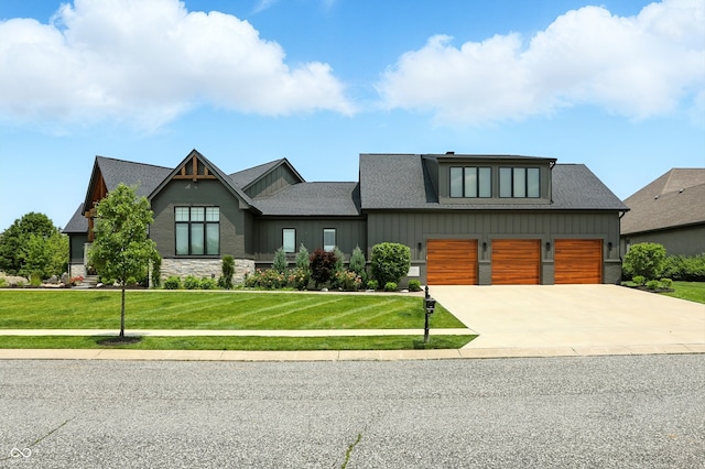 7116 Trail Ridge Ln, Indianapolis, IN 46259 - view of front of property featuring board and batten siding, driveway, a front yard, a garage, and a shingled roof