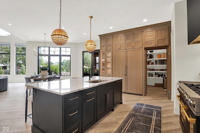 7116 Trail Ridge Ln, Indianapolis, IN 46259 - kitchen with stove, a chandelier, a center island with sink, recessed lighting, and light stone counters